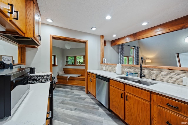 411 N 400 W, West Lafayette, IN 47906 - kitchen featuring stainless steel appliances, decorative backsplash, a sink, light wood-type flooring, and light countertops