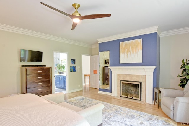 11130 Summitree Ct, Evansville, IN 47725 - bedroom featuring crown molding, light wood-style floors, a fireplace, ensuite bath, and ceiling fan