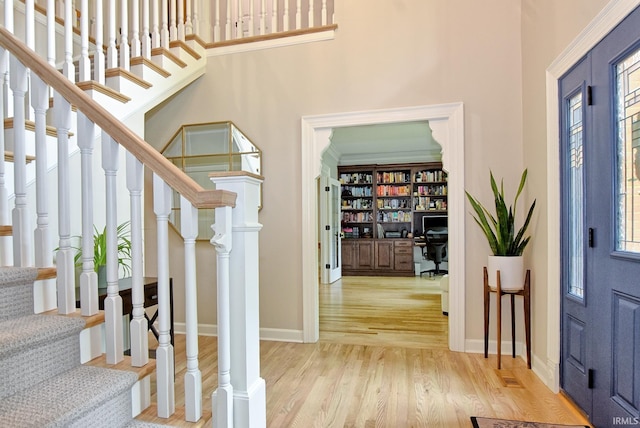 11130 Summitree Ct, Evansville, IN 47725 - foyer entrance with light wood-type flooring, stairway, a towering ceiling, and baseboards