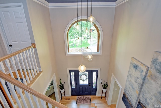11130 Summitree Ct, Evansville, IN 47725 - foyer entrance with healthy amount of natural light, a high ceiling, a chandelier, stairway, and crown molding