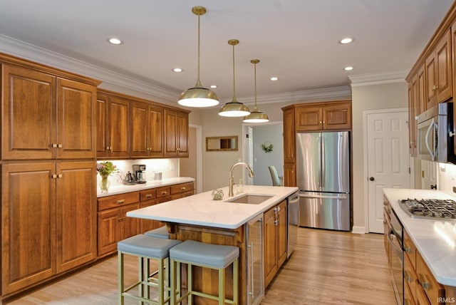 11130 Summitree Ct, Evansville, IN 47725 - kitchen featuring appliances with stainless steel finishes, a sink, brown cabinetry, an island with sink, and recessed lighting