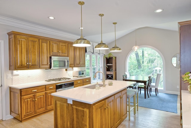 11130 Summitree Ct, Evansville, IN 47725 - kitchen with appliances with stainless steel finishes, a sink, brown cabinets, light countertops, and tasteful backsplash