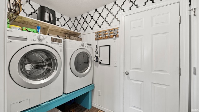 12946 Magnolia Creek Trl, Fort Wayne, IN 46814 - laundry area with washer and clothes dryer, a textured ceiling, and wood finished floors