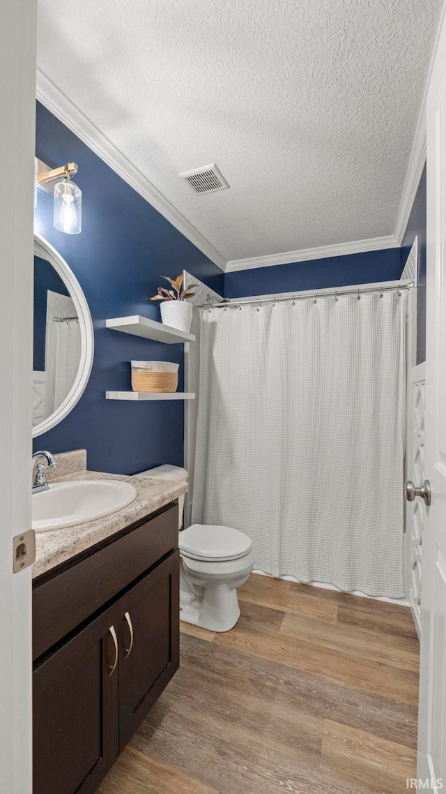 12946 Magnolia Creek Trl, Fort Wayne, IN 46814 - bathroom with vanity, a textured ceiling, wood finished floors, toilet, and crown molding