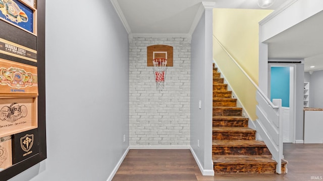12946 Magnolia Creek Trl, Fort Wayne, IN 46814 - stairway featuring crown molding, wood finished floors, baseboards, and brick wall