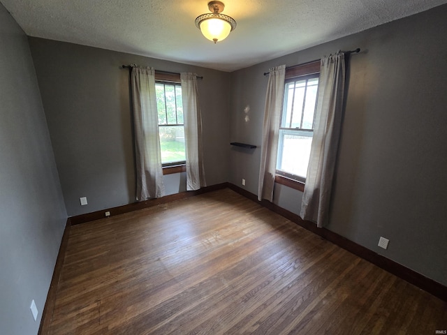 135 S 27th St, Lafayette, IN 47904 - empty room featuring wood finished floors, a textured ceiling, and baseboards