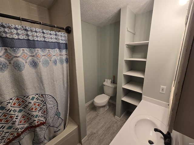 135 S 27th St, Lafayette, IN 47904 - full bath with a sink, a textured ceiling, a shower with shower curtain, wood finished floors, and toilet