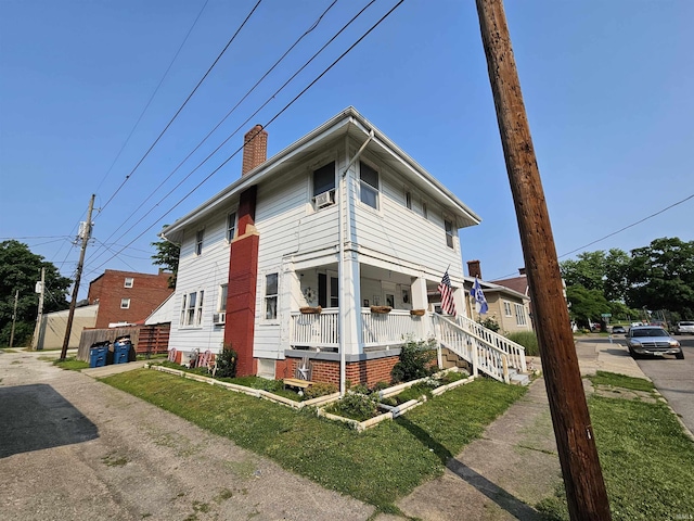 209 Seminary St, Vincennes, IN 47591 - view of side of home with covered porch and a chimney