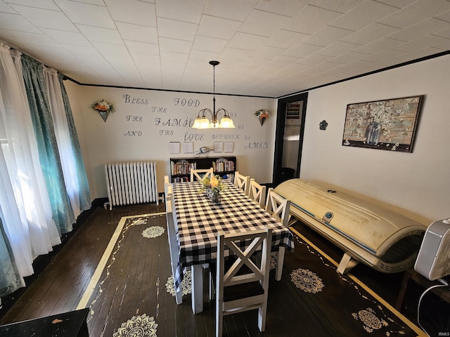 209 Seminary St, Vincennes, IN 47591 - dining space with radiator heating unit, a chandelier, and wood-type flooring