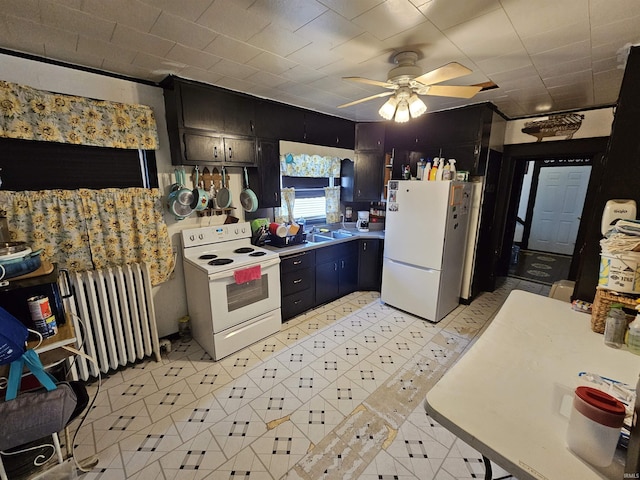 209 Seminary St, Vincennes, IN 47591 - kitchen featuring white appliances, radiator heating unit, light countertops, a sink, and a ceiling fan