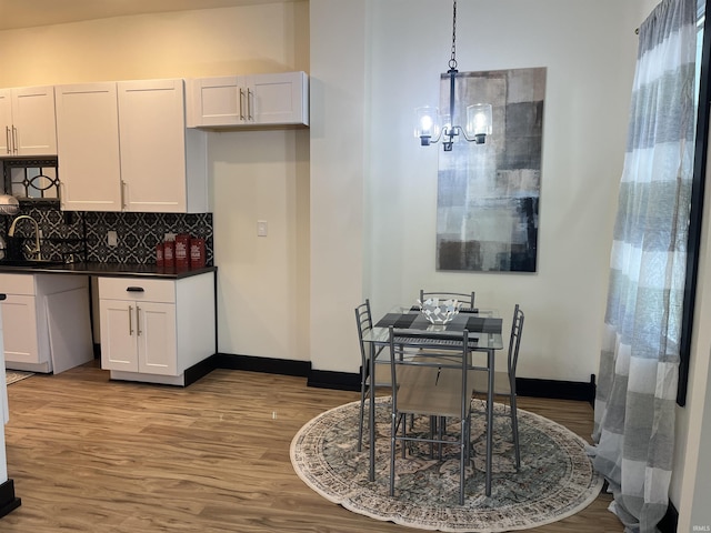 1302 Linden Ave, South Bend, IN 46628 - dining space with light wood-style floors, a chandelier, and baseboards