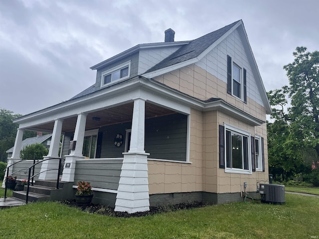 1302 Linden Ave, South Bend, IN 46628 - view of side of home with cooling unit, covered porch, a chimney, and a yard