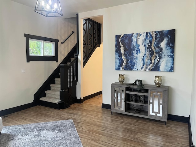 1302 Linden Ave, South Bend, IN 46628 - staircase with wood finished floors, a chandelier, and baseboards