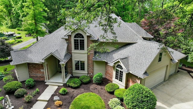 6011 W Wallen Rd, Fort Wayne, IN 46818 - traditional-style house featuring brick siding, a shingled roof, and a garage