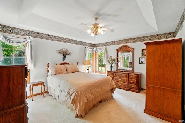 6011 W Wallen Rd, Fort Wayne, IN 46818 - bedroom featuring a tray ceiling, carpet flooring, baseboards, and a ceiling fan