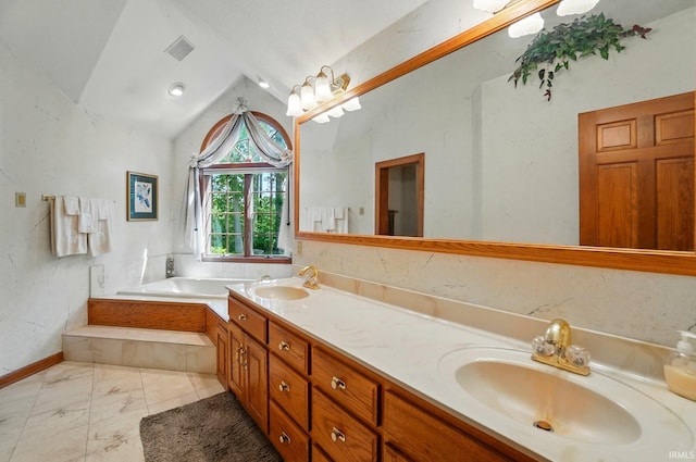 6011 W Wallen Rd, Fort Wayne, IN 46818 - bathroom with vaulted ceiling, marble finish floors, double vanity, and a garden tub