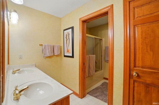 6011 W Wallen Rd, Fort Wayne, IN 46818 - bathroom featuring double vanity, shower / bath combination with glass door, and tile patterned floors