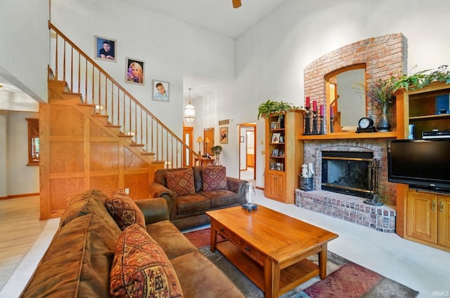 6011 W Wallen Rd, Fort Wayne, IN 46818 - living area featuring a brick fireplace, stairs, a towering ceiling, and ceiling fan