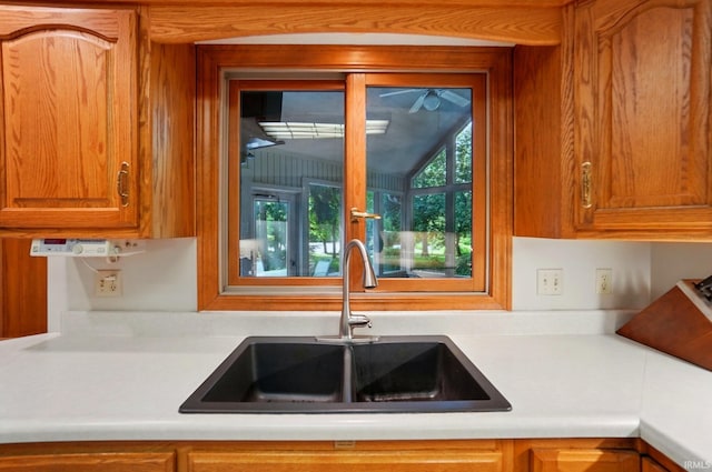 6011 W Wallen Rd, Fort Wayne, IN 46818 - kitchen featuring a sink, light countertops, and brown cabinets
