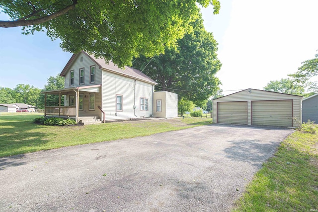 9031 Mill St, Stockwell, IN 47983 - view of home's exterior with covered porch, a garage, an outdoor structure, and a yard