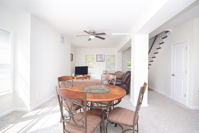 9031 Mill St, Stockwell, IN 47983 - dining room with light carpet, a ceiling fan, stairway, and baseboards