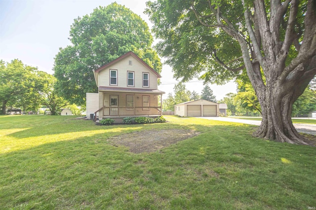 9031 Mill St, Stockwell, IN 47983 - back of house featuring a porch, an outbuilding, a detached garage, and a lawn