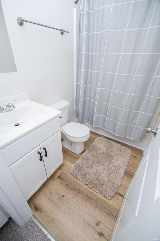 9031 Mill St, Stockwell, IN 47983 - full bathroom with vanity, toilet, and curtained shower