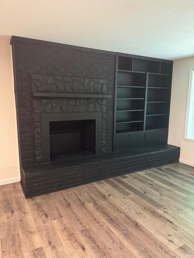 701 Ravine Park Blvd, Attica, IN 47918 - detailed view of a fireplace with raised hearth, wood finished floors, and baseboards