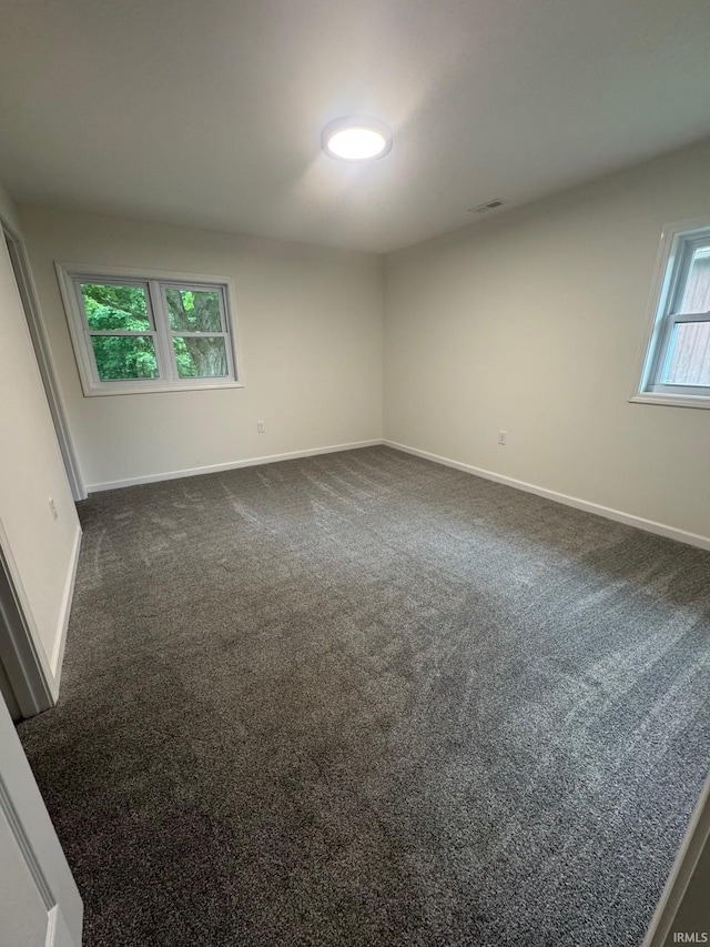 701 Ravine Park Blvd, Attica, IN 47918 - empty room with baseboards and dark colored carpet
