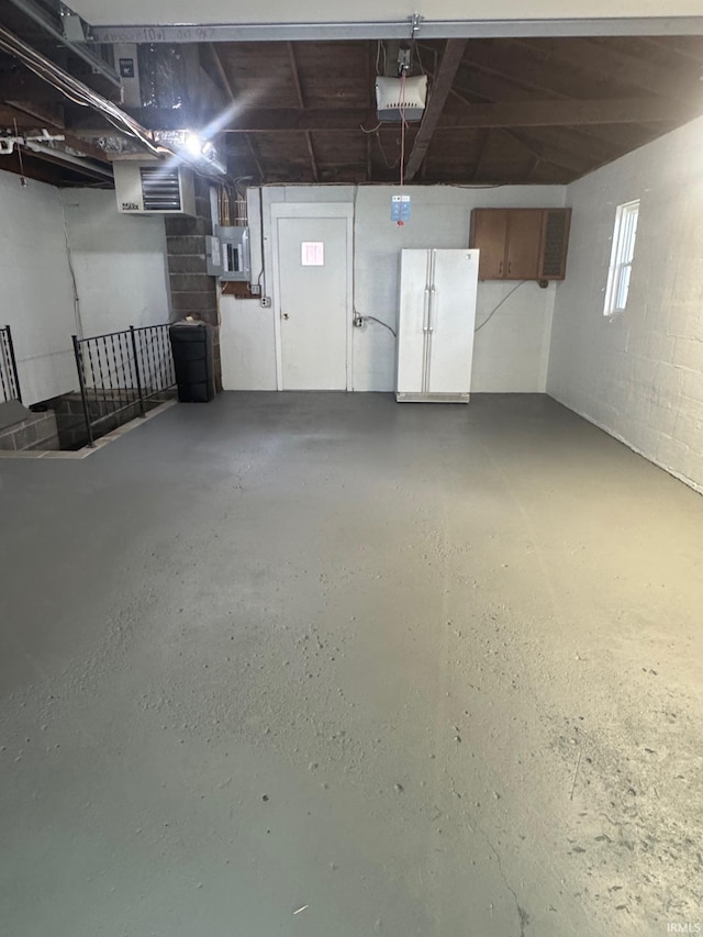 701 Ravine Park Blvd, Attica, IN 47918 - garage with a garage door opener and freestanding refrigerator