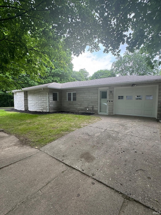 701 Ravine Park Blvd, Attica, IN 47918 - view of front of house featuring a garage, stone siding, concrete driveway, and a front lawn