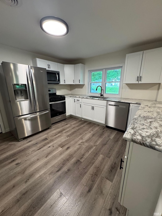 701 Ravine Park Blvd, Attica, IN 47918 - kitchen with appliances with stainless steel finishes, a sink, dark wood-style flooring, and white cabinets