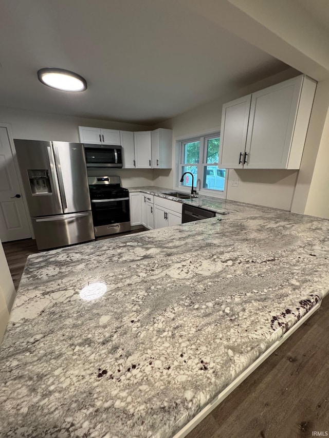 701 Ravine Park Blvd, Attica, IN 47918 - kitchen with appliances with stainless steel finishes, dark wood-style floors, light stone countertops, and white cabinets