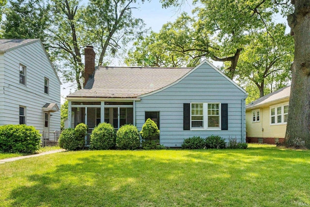 2217 Inglewood Pl, South Bend, IN 46616 - view of front facade featuring a chimney, a front lawn, and roof with shingles