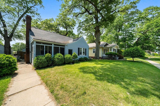 2217 Inglewood Pl, South Bend, IN 46616 - view of front of property featuring a front lawn, a chimney, and a shingled roof