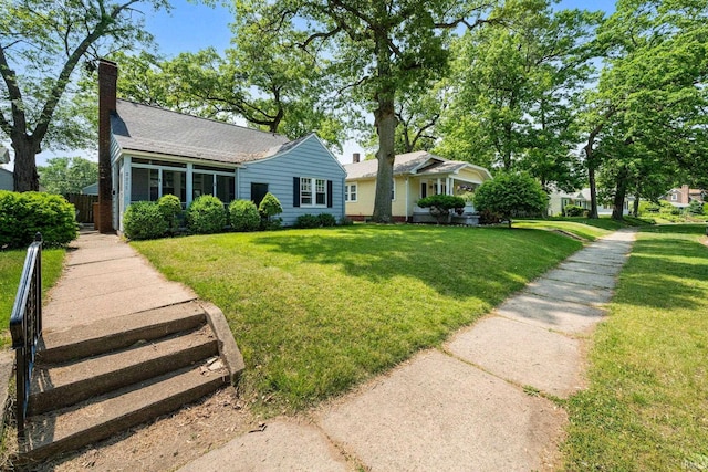 2217 Inglewood Pl, South Bend, IN 46616 - view of front of home featuring a shingled roof and a chimney