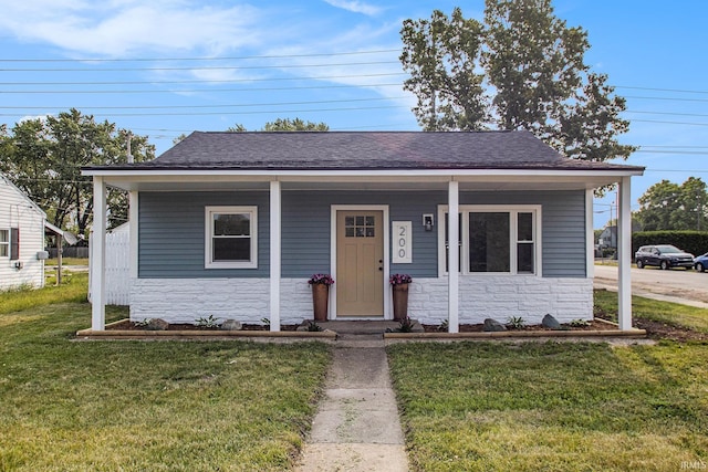 200 Johnson St, Elkhart, IN 46516 - bungalow-style home featuring stone siding, a front lawn, a shingled roof, and a porch