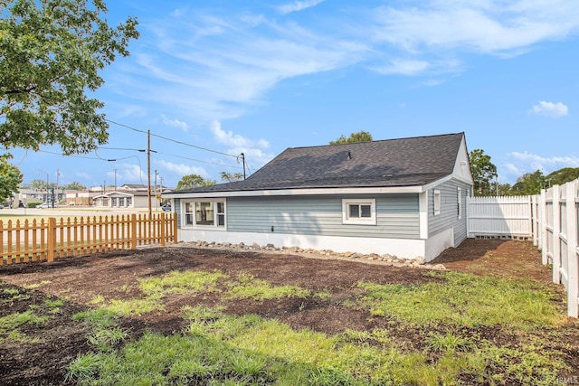 200 Johnson St, Elkhart, IN 46516 - rear view of house with a fenced backyard and a shingled roof