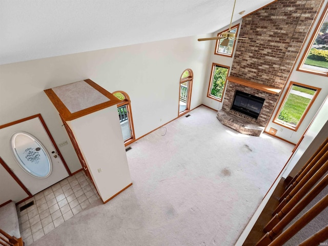 509 Water Meade Pl, Fort Wayne, IN 46825 - unfurnished living room with a fireplace, ceiling fan, high vaulted ceiling, carpet flooring, and baseboards