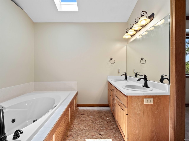 509 Water Meade Pl, Fort Wayne, IN 46825 - bathroom featuring a skylight, double vanity, a tub with jets, and baseboards