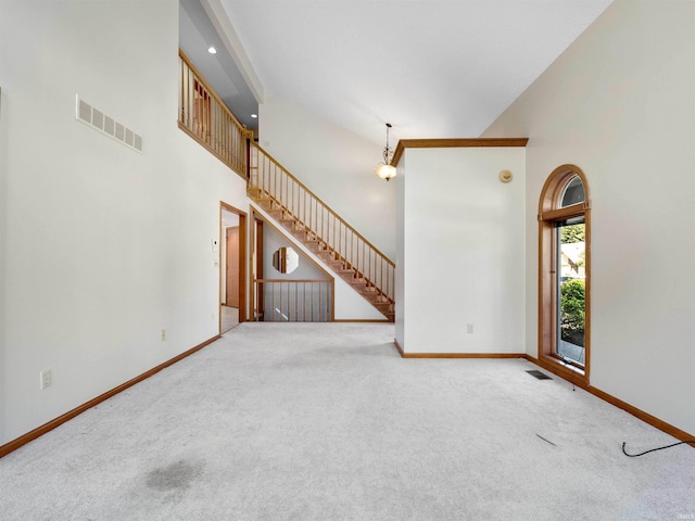 509 Water Meade Pl, Fort Wayne, IN 46825 - unfurnished living room with baseboards, high vaulted ceiling, carpet, and stairway