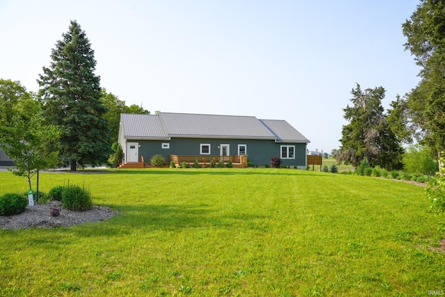 7458 E Lincolnway Rd, Columbia City, IN 46725 - back of house featuring a deck, a lawn, and metal roof