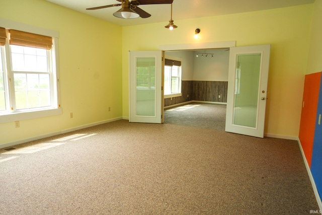 7458 E Lincolnway Rd, Columbia City, IN 46725 - empty room with carpet flooring, a ceiling fan, and french doors