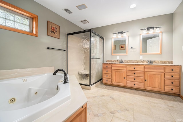 1708 Canterbury Dr, Elkhart, IN 46514 - full bathroom with double vanity, a stall shower, a jetted tub, and tile patterned floors