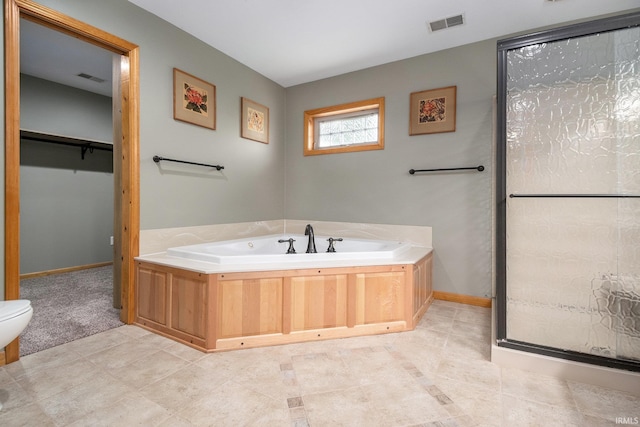 1708 Canterbury Dr, Elkhart, IN 46514 - bathroom featuring a garden tub, toilet, baseboards, a spacious closet, and a stall shower