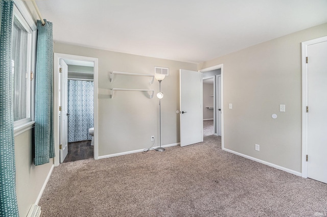 1708 Canterbury Dr, Elkhart, IN 46514 - unfurnished bedroom featuring carpet, baseboards, and ensuite bath