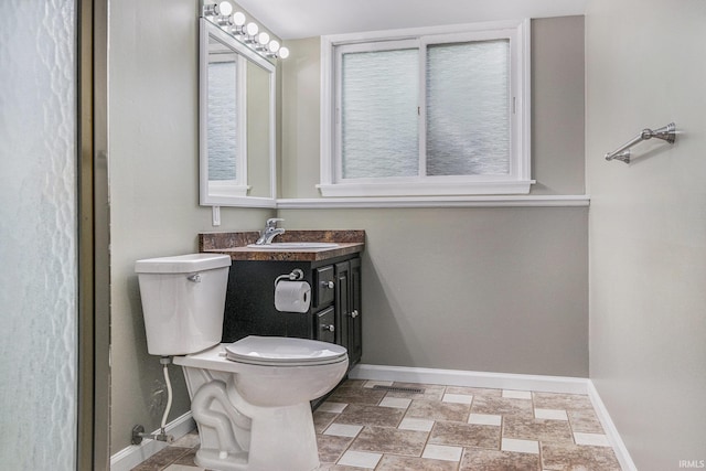 1708 Canterbury Dr, Elkhart, IN 46514 - bathroom featuring baseboards, vanity, toilet, and stone finish floors
