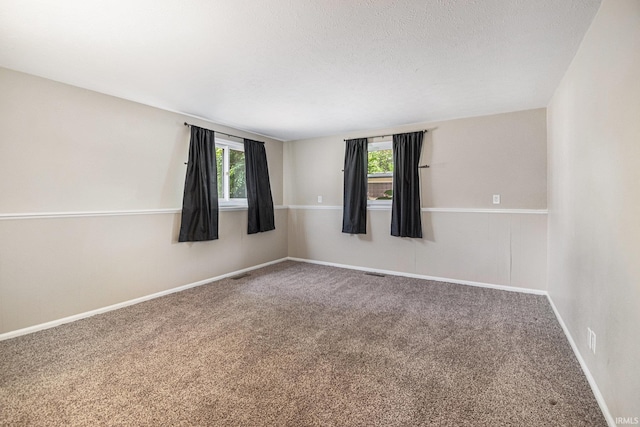 1708 Canterbury Dr, Elkhart, IN 46514 - unfurnished room featuring carpet, baseboards, and a textured ceiling