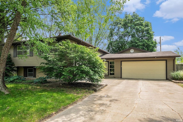 1708 Canterbury Dr, Elkhart, IN 46514 - view of front facade featuring an attached garage, concrete driveway, and a front lawn