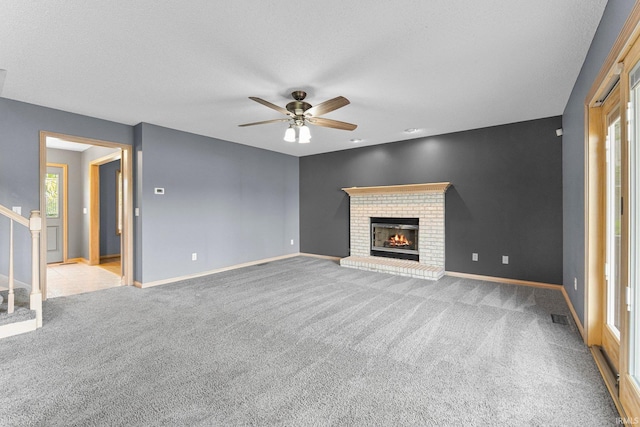 9529 Skipjack Cv, Fort Wayne, IN 46835 - unfurnished living room with ceiling fan, carpet floors, a fireplace, and baseboards